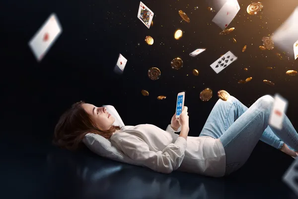 678DB App — Enjoy seamless gaming on your smartphone A young woman relaxing with her phone while dynamic casino elements float around her, illustrating the smooth mobile experience offered by the 678DB app.