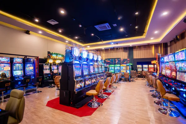 A glamorous woman holding casino chips in a neon-lit environment, representing the premium online casino atmosphere of 678DB.