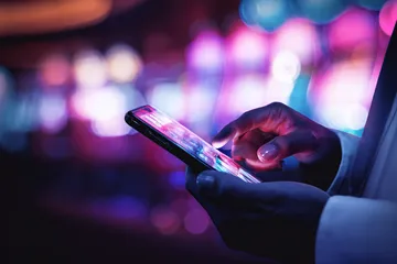 678DB Slots — Thousands of thrilling machines await A woman smiling by bright slot machines showing lucky symbols, showcasing the exciting slot offerings at 678DB.